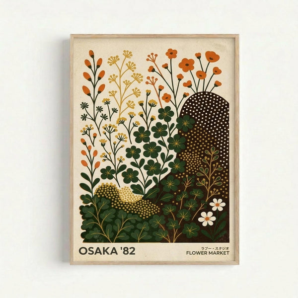 A framed botanical poster featuring stylized wildflowers and plants in earthy tones of orange, yellow, and green against a cream background. The artwork includes detailed illustrations of various flowering stems, clover-like plants, and decorative dotted patterns in black and gold. Text at bottom reads "OSAKA '82" and "FLOWER MARKET" in Japanese and English. The print is displayed in a light wooden frame against a white wall.
