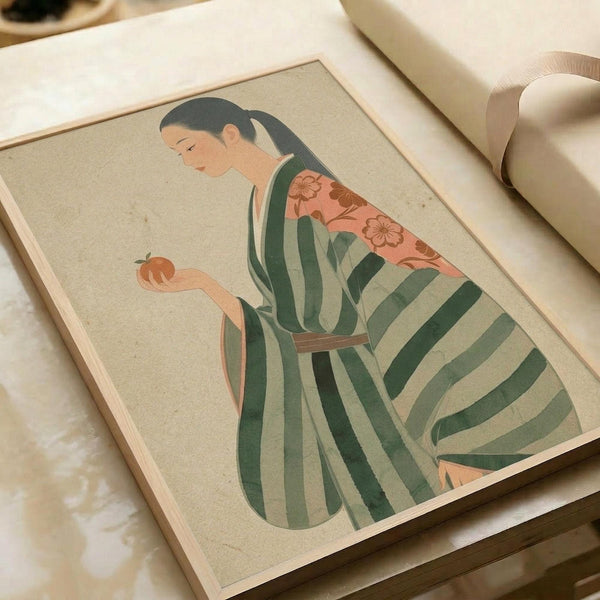 May include: Japanese art print displayed on white paper surface next to cream ribbon roll. Artwork shows woman in profile wearing green and white striped kimono with coral floral pattern at shoulders, dark hair in ponytail, holding small orange persimmon fruit. Illustrated in soft, muted colors with traditional woodblock print aesthetic on beige background.
