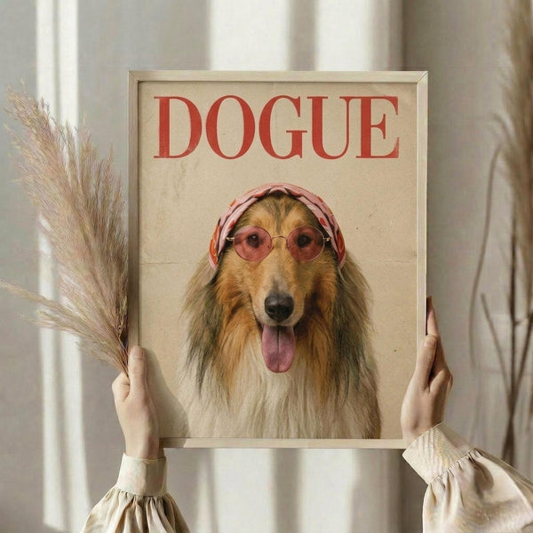 May include: Framed poster featuring a Rough Collie dog wearing pink round sunglasses and a pink headscarf against a cream background, with red "DOGUE" text at top mimicking fashion magazine style. Person in beige clothing holds the light wood frame while also holding dried wheat stems. Neutral indoor setting with white curtains visible in soft natural lighting.