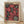 May include: Framed vintage-style poster featuring large pink and coral flowers with black centers filled with white dots, set against a black background with scattered white polka dots. The poster displays "JAPAN WEEK" text at top with Japanese characters and "1984" and "TOKYO" in corners. Natural wood frame sits on light wooden flooring against white wall with soft shadows.