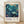 May include: Framed vintage exhibition poster featuring underwater scene with whales, coral, and sea plants in turquoise and teal tones. Japanese text and "JAPAN 1984" visible below artwork. Light wooden frame displayed against white textured wall on wooden floor with soft natural lighting creating shadows.