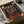 May include: Black framed poster featuring a Rottweiler dog wearing a chunky red knit sweater against a dark background, with "DOGUE" text at the top in cream lettering. The print is packaged in a cardboard shipping box with white tissue paper padding, shown alongside wooden rolling pin and glass jar on a neutral surface.