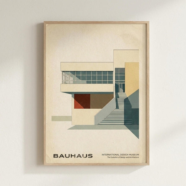 May include: Framed architectural poster featuring geometric modernist building illustration in muted tones of cream, teal, rust and sage green, showing angular structure with grid windows and stairs, displayed on light wall in wooden frame with cream matting