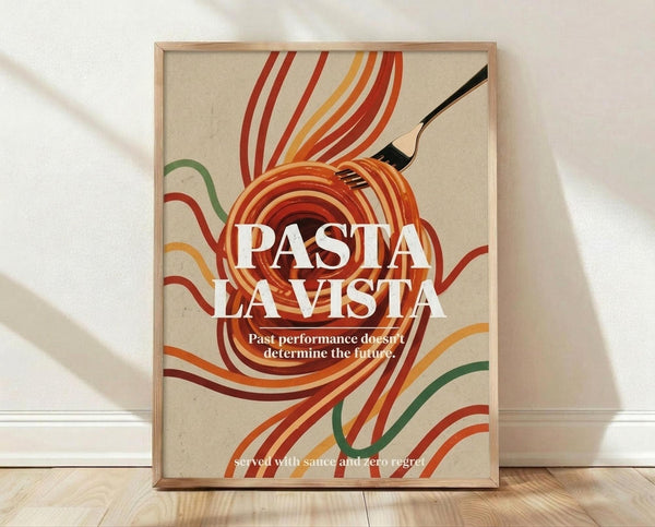 May include: Framed retro-style poster with swirling orange, red, yellow and green pasta noodles around a black fork on cream background. Bold white text reads "PASTA LA VISTA" with smaller text below. Natural wood frame sits on light hardwood floor against white wall with soft shadows.