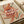 May include: Retro-style poster with swirling orange, red, and green pasta noodles forming dynamic curves across beige background. Large white text reads "PASTA LA VISTA" with smaller tagline below. Black fork illustration appears in upper portion. Print displayed in light wooden frame on white surface next to rolled kraft paper.