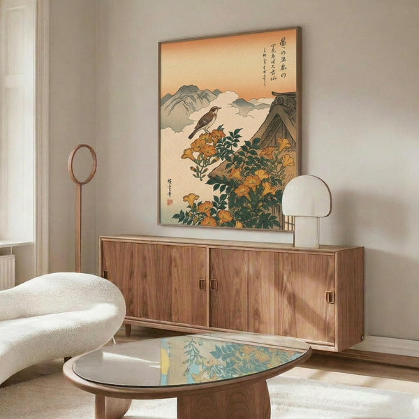 May include: Japanese woodblock print artwork featuring a bird perched on orange trumpet vine flowers with mountains and traditional architecture in background, displayed in thin frame above mid-century modern walnut credenza in minimalist living room with cream walls, white sculptural chair, glass-top coffee table, and warm natural lighting