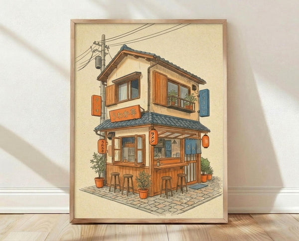 May include: Framed illustration of a charming two-story Japanese ramen shop with warm wooden exterior, traditional tile roof, and red paper lanterns. The cozy building features outdoor seating with wooden stools, potted plants, colorful shop signs with Japanese characters, and power lines overhead. The artwork has a soft, vintage-style appearance with cream background, displayed in a light wooden frame leaning against a white wall on wooden flooring.