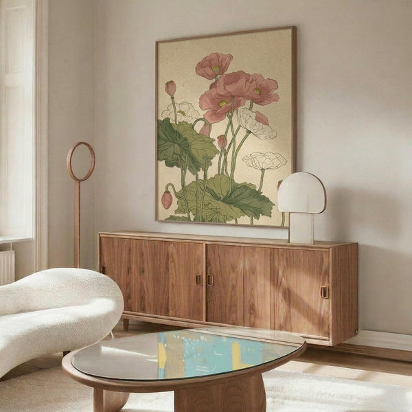 May include: Vintage botanical artwork displaying pink and white poppies with green foliage on cream background, shown in thin wood frame above mid-century walnut credenza. Modern white curved chair and glass-top oval coffee table complete the warm, minimalist living room setting with natural lighting.