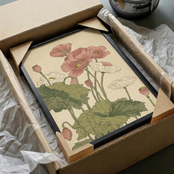 May include: Vintage botanical illustration of pink and white poppies with green stems and leaves displayed in black frame, being unpacked from cardboard shipping box with protective tissue paper on white surface