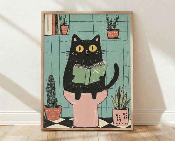 May include: Framed poster print leaning against white wall on wooden floor. Artwork shows black cat with yellow eyes sitting on pink toilet, reading green book. Turquoise tiled bathroom background with terra cotta plant pots containing cacti and succulents on shelves and floor. Illustration has textured, hand-drawn style with speckled details. Natural wood frame surrounds the colorful print in this cozy room mockup scene.