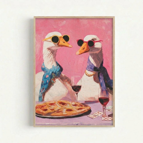 May include: Framed artwork showing two white geese wearing sunglasses sitting at a dinner table with pizza and red wine glasses against a pink background. The geese wear colorful scarves - one blue with patterns, one purple. Playing cards are scattered on the table. The painting has visible brushstroke texture and is displayed in a light wood frame on a white wall.