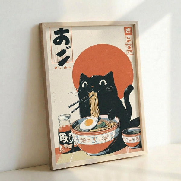 Framed poster in light wood frame leaning against white wall, featuring a black cat with white eyes eating ramen noodles with chopsticks. The cat sits behind a decorative bowl with an egg and noodles, alongside a small bottle. A large orange circle resembling the sun fills the background. Japanese text appears in the upper left and right corners. The artwork uses a vintage Japanese woodblock print style with cream, orange, and black colors on textured paper background.
