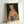 May include: Framed art print featuring a stylized leopard wearing green sunglasses, coral ribbed turtleneck, leopard print coat, and blue striped pants while holding a pink purse, set against a black background in a light wood frame, leaning against a white wall