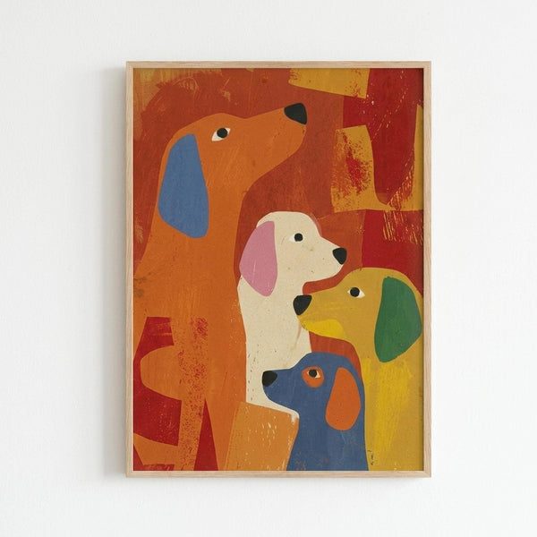 Framed colorful illustration of four stylized dogs in profile view arranged vertically. The dogs feature bright colors - orange with blue ear at top, white with pink ear, yellow with green ear, and blue with orange ear at bottom. The artwork has a textured, painterly style with warm red and orange background colors. Displayed in a light wood frame against a white wall.