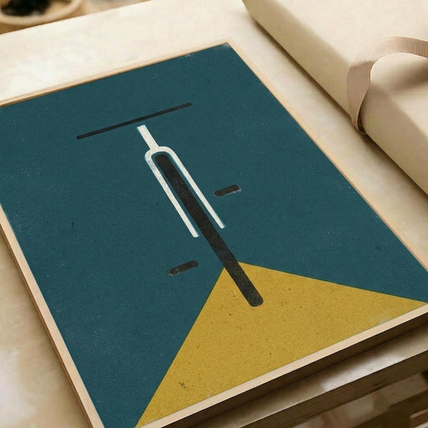 Minimalist geometric artwork on teal and mustard yellow background featuring abstract white and black linear shapes resembling a simplified bicycle front view. The print is displayed flat on white paper with a cream ribbon visible in the corner, showing the artwork's clean lines and modern color palette against the neutral backdrop.