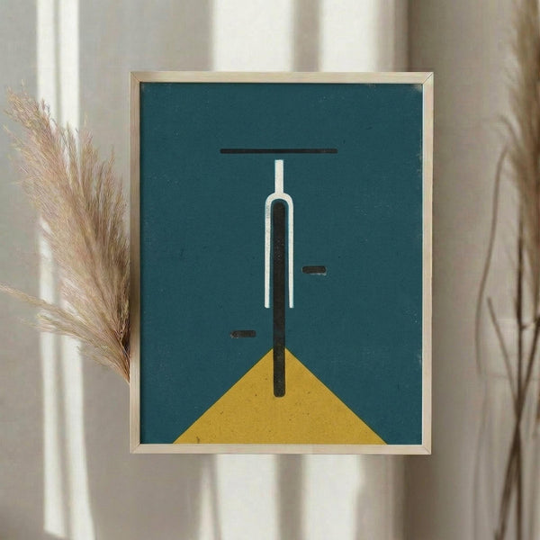 May include: Framed abstract art print with teal blue background and yellow triangle base, featuring minimalist white and black linear bicycle design. Light wooden frame hangs on neutral wall beside dried pampas grass stems in soft natural lighting.