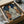 May include: Framed artwork in cardboard packaging with protective wrapping, showing a portrait of a woman with red hair in profile wearing a blue and cream leaf-patterned garment, surrounded by large brown and cream flowers against a deep blue background, styled as vintage botanical illustration