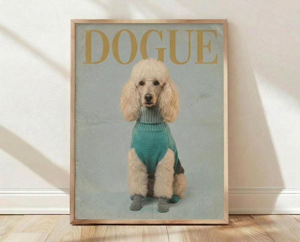 May include: Framed poster print leaning against white wall on wooden floor. Features cream-colored poodle wearing teal turtleneck sweater and matching booties against sage green background. Gold "DOGUE" text at top mimics fashion magazine style. Natural wood frame, soft window lighting creates shadows on textured wall.
