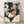 May include: Framed art print featuring a stylized koi fish with coral-pink scales and flowing fins swimming among cream and sage green ginkgo leaves against a dark navy background dotted with small white spots. The artwork has a Japanese-inspired aesthetic with flowing organic shapes and is displayed in a light wood frame leaning against a white wall on wooden flooring with soft natural lighting.