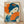 May include: Framed Japanese-style poster print leaning against white wall on light wood floor. Artwork features woman with traditional blue upswept hair adorned with orange flowers, holding bright orange folding fan. Styled in vintage woodblock print aesthetic with blue and orange color palette. Orange Japanese characters visible in upper left. Natural wood frame, soft shadows from window light across white textured wall.
