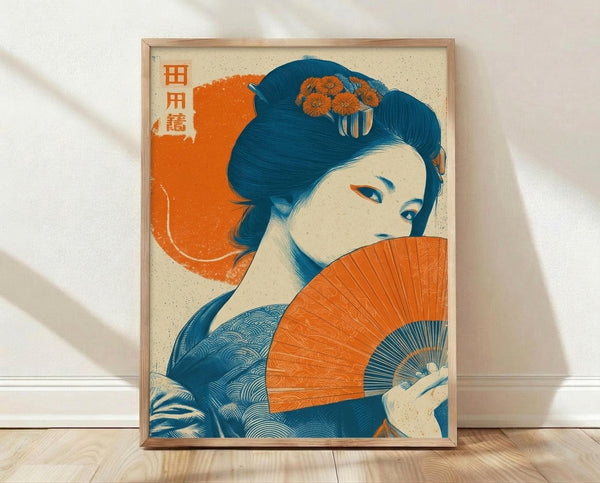 May include: Framed Japanese-style poster print leaning against white wall on light wood floor. Artwork features woman with traditional blue upswept hair adorned with orange flowers, holding bright orange folding fan. Styled in vintage woodblock print aesthetic with blue and orange color palette. Orange Japanese characters visible in upper left. Natural wood frame, soft shadows from window light across white textured wall.