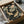May include: Japanese-style artwork featuring two golden koi fish swimming among pink lotus flowers and large green lily pads on a dark background, displayed in a black frame nestled in cardboard packaging with white tissue paper and wooden protective corners