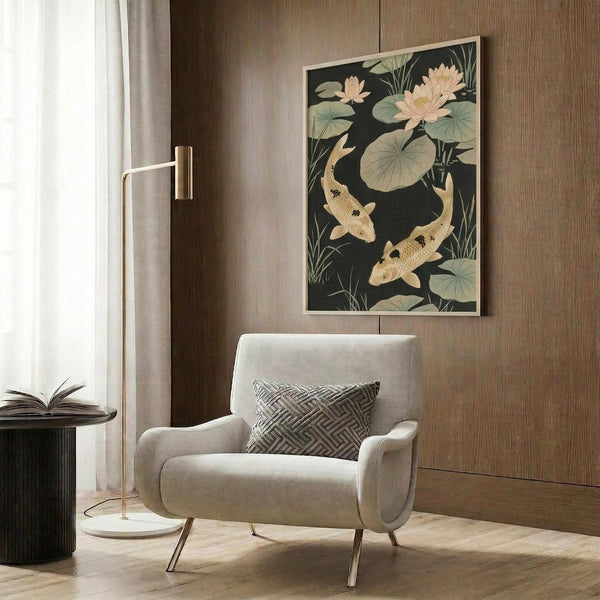 May include: Framed vintage Japanese art print featuring two golden koi fish swimming among lotus flowers and lily pads on dark green background, displayed above beige upholstered armchair with geometric pillow in modern living room with wood paneled wall, brass floor lamp, and side table with open book.
