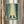 May include: Framed artwork displaying two samurai warriors engaged in sword combat within a misty bamboo forest, rendered in teal and cream tones with Japanese artistic style, hanging on a neutral wall beside dried pampas grass in a modern interior setting