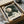May include: Vintage-style poster featuring Japanese umbrellas in cream, dark green, and muted blue tones with dotted patterns and radiating spoke designs, displayed in black frame inside cardboard shipping box with protective tissue paper wrapping on neutral surface.