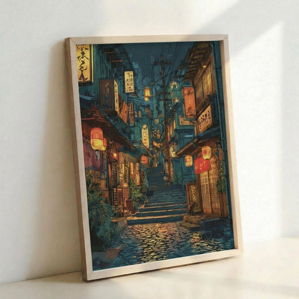 May include: Framed poster print leaning against white wall showing atmospheric Japanese alleyway scene at night with warm glowing lanterns, traditional wooden buildings, stone steps leading upward, and wet cobblestones reflecting light. Artwork features deep blue and teal evening tones contrasted with golden yellow illumination from paper lanterns and shop signs with Japanese characters. Natural wood frame surrounds the detailed illustration in anime or manga art style.