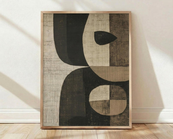 May include: Abstract geometric art print in natural wood frame leaning against white wall on light wooden floor. Artwork features overlapping curved and circular shapes in dark green and cream tones with weathered, textured surfaces. Soft natural lighting creates diagonal shadows across the scene.