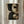 May include: Framed abstract geometric artwork with organic curved shapes in black, cream, and brown earth tones, displayed on white wall beside flowing curtains. The composition features overlapping semicircles and rounded forms with a weathered, textured appearance in natural wood frame.