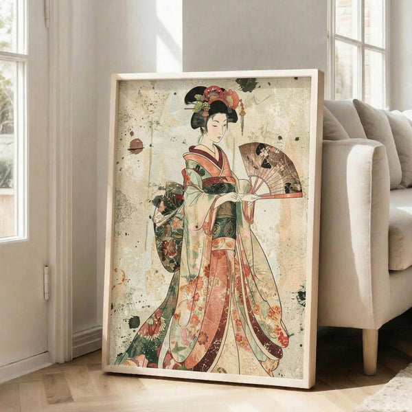 May include: Framed Japanese-style artwork featuring a woman in an elaborate floral kimono holding a decorative fan, displayed on hardwood flooring next to a beige upholstered chair near tall windows. The vintage-inspired print has weathered texturing with ink splatters and shows rich colors of coral, green, and cream against an aged background.