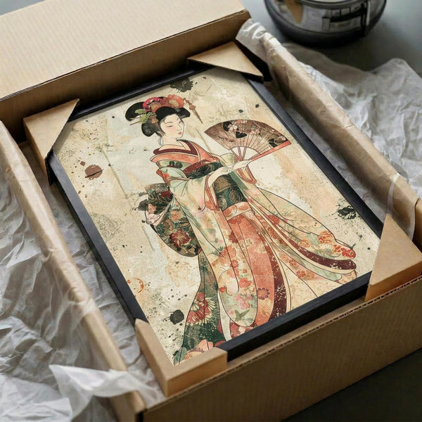 May include: Framed artwork showing a Japanese woman in flowing kimono with red, green, and coral floral patterns, holding a decorative fan. The print has an aged, vintage appearance with weathered texture and dark spots. Black frame sits in wooden shipping box with brown paper padding on white fabric surface.