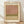 May include: Framed poster print featuring abstract color field artwork with soft horizontal bands in muted pink, olive green, and cream tones. The print has aged, vintage-style coloring and is displayed in a light wood frame against white fabric backdrop on wooden flooring with natural window light casting shadows.