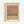 A framed art print displaying an abstract composition with horizontal bands of muted colors - soft pink at the top, olive green in the middle, and cream at the bottom, with blended, watercolor-like edges between the sections. The artwork is matted in cream with black text above and below, housed in a light wood frame and mounted on a white wall.