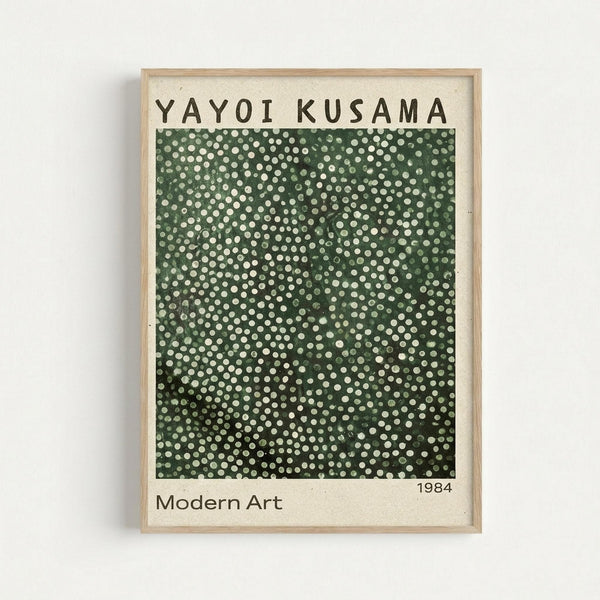 Framed poster featuring Yayoi Kusama's signature polka dot pattern in varying shades of green with white dots densely covering the entire surface. The artwork has a gradient effect from lighter green at top to darker forest green at bottom. Text reads "YAYOI KUSAMA" at top, "Modern Art" and "1984" at bottom on cream background. Light wood frame against white wall.