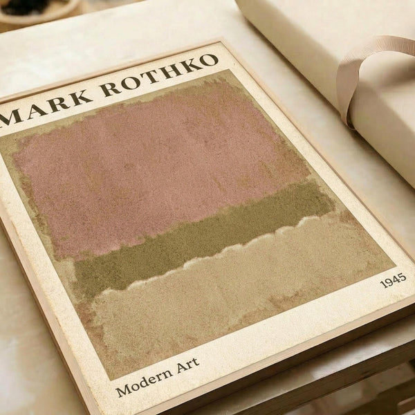 May include: Abstract art print with soft pink and olive green horizontal color fields in minimalist style, displayed in an open art book or catalog. The artwork shows muted earth tones with organic, cloud-like edges between color blocks. White ribbon bookmark visible alongside cream-colored pages in warm, natural lighting.