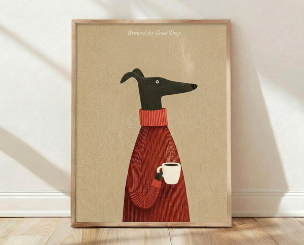 May include: Framed poster print leaning against white wall on wooden floor with natural lighting and shadows. Shows minimalist illustration of black greyhound wearing red ribbed sweater, holding white coffee mug. Tan beige background with "Brewed for Good Dogs" text and steam wisps. Light wood frame, clean modern home decor style.