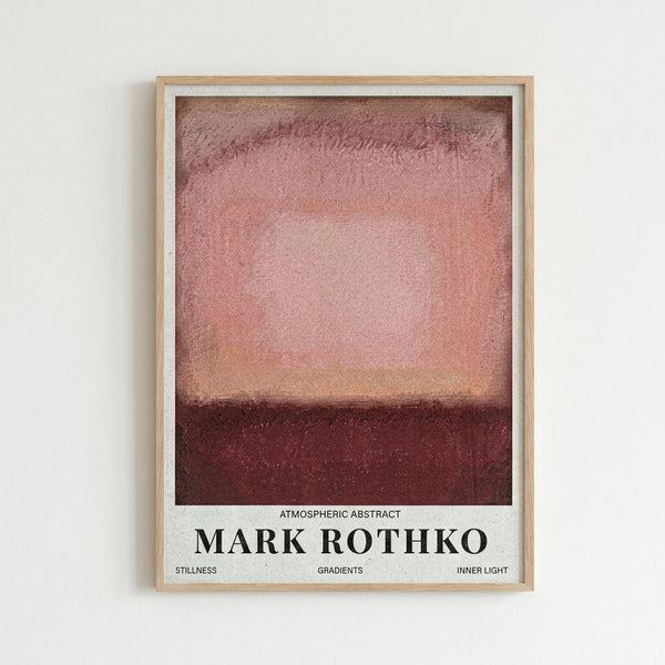 May include: Framed poster print featuring a Mark Rothko-inspired abstract painting with soft horizontal color blocks in dusty pink, coral, and deep burgundy tones. The artwork has a textured, painterly appearance with blended edges between color fields. White text below reads "ATMOSPHERIC ABSTRACT MARK ROTHKO" with smaller text mentioning "STILLNESS GRADIENTS INNER LIGHT." Light wooden frame hangs on white wall.