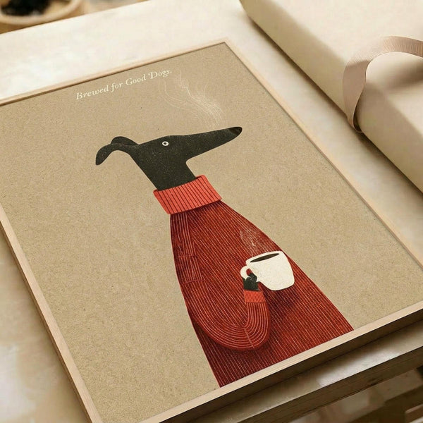 May include: Art print on beige paper showing a black greyhound wearing a red ribbed sweater, holding a white coffee cup with steam rising above. The minimalist illustration has "Brewed for Good Dogs" text at top. Print is displayed on white wrapping paper with cream ribbon nearby, creating a gift presentation scene.