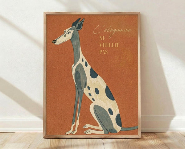 May include: Framed poster print leaning against white wall on light wood floor. Orange textured background features stylized greyhound illustration in cream and teal colors with spotted pattern. French text "L'élégance ne vieillit pas" in golden script lettering. Natural wood frame, soft window light casting shadows on wall.