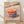 May include: Framed poster print leaning against white wall on light wooden floor with natural shadows. Features colorful illustrated stack of pancakes with vibrant dripping syrup in rainbow hues against peachy pink background. Japanese text at top and "itadakimasu" at bottom. English subtitle reads "Pancake Paradise: Stack Your Happiness! Fluffy, Golden, and Irresistible." Light wooden frame complements the warm tones of the artwork.
