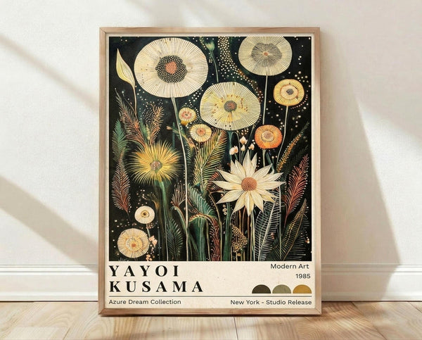 May include: Framed botanical art print leaning against white wall on light wood floor. Black background with cream and yellow flowers in detailed scientific illustration style, featuring large circular blooms, ferns, and delicate stems with dotted textures. Natural wood frame, soft lighting creates gentle shadows on textured white fabric backdrop.