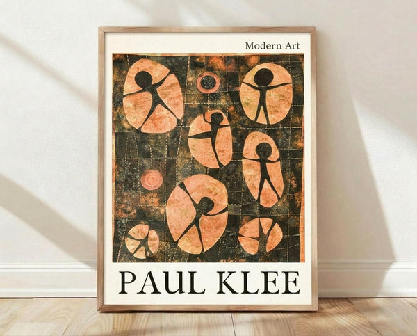 May include: Framed art print leaning against white wall on light wood floor. The poster features abstract figures in peachy-orange tones against dark gridded background, reminiscent of mid-century modern style. Simple wooden frame with white matting. Natural lighting creates soft shadows on textured white wall behind the artwork.