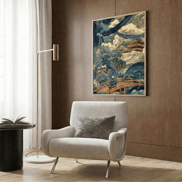 May include: Japanese woodblock print artwork displayed in modern living room setting with beige upholstered chair, gold floor lamp, and wood paneled wall. Artwork features dramatic blue swirling waters, mountains, trees, and wooden bridge in traditional ukiyo-e style with earth tones and deep blues. Print appears framed and hung above contemporary furniture on warm wood grain background.