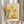 May include: A framed art print featuring botanical illustrations in yellow and green tones with dotted patterns and abstract floral motifs, displayed on a beige fabric backdrop with dried pampas grass stems visible to the left. The artwork shows stylized plants and flowers with polka dot textures in an organic, modern style within a light wood frame.