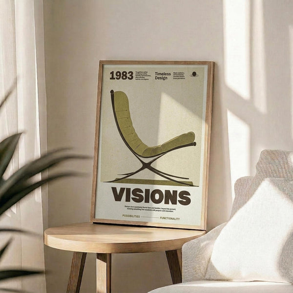 May include: Framed vintage-style design poster featuring olive green Barcelona-style chair illustration on cream background, displayed on round wooden side table next to beige upholstered chair with throw pillow. Natural sunlight streams across neutral-toned room with plant leaves visible in corner. Poster shows "1983," "Timeless Design," and "VISIONS" text in modern typography within thin wooden frame.