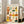 May include: Framed art print leaning against white wall next to beige sofa in bright living room with windows. Poster features twelve colorful illustrated portrait squares arranged in grid format with "SOIS UNIQUE" text at top. Each portrait shows different stylized person with varied skin tones, hairstyles, clothing, and accessories in warm oranges, greens, yellows, and blues. Light wooden frame, approximately 2-3 feet tall based on sofa scale.