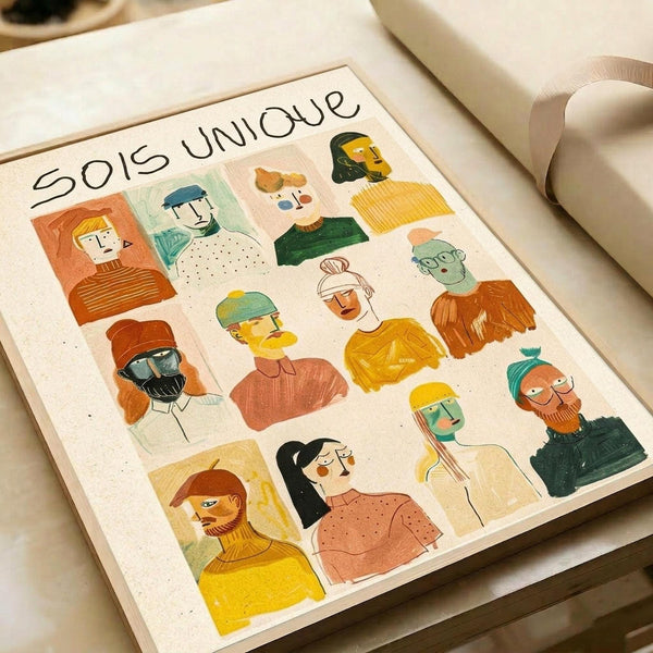 May include: Illustrated poster print featuring diverse portrait illustrations in colorful rectangular frames, showing people with various hairstyles, clothing, and skin tones in warm yellows, oranges, greens, and blues. The French text "SOIS UNIQUE" appears at the top. Print is displayed on white paper with neutral wrapping paper and ribbon visible in background, creating a gift-ready presentation scene.